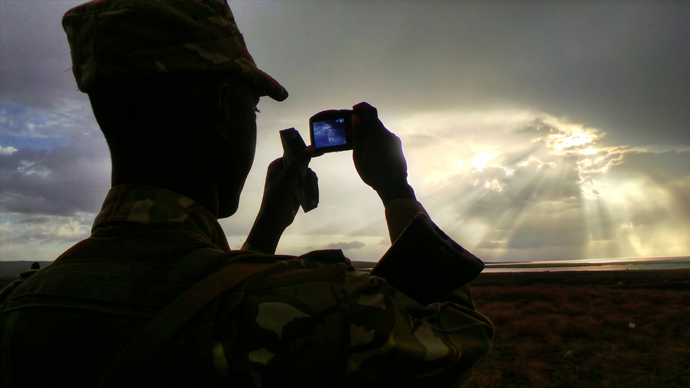 turkana eclipse_soldier taking pic