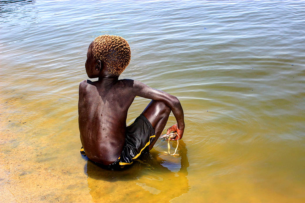 Sights & People from the North Rift_Turkana boy with fish